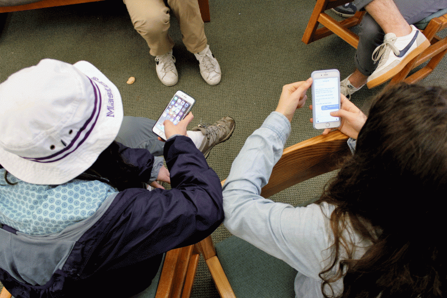 Seniors Isabelle Davis and Sophia Gutfreund play on their phones in the McKnight Room.  Students at Masters can often be seen attached to their phones in the dining hall, walking from class to class, and in the library.  