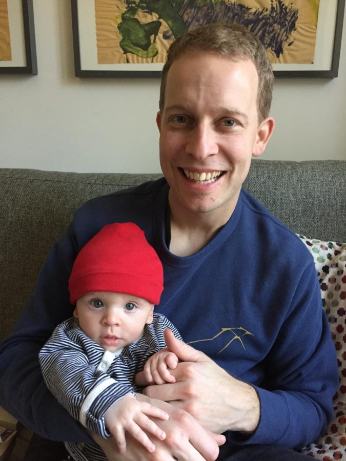 Darren Wood sits at home with his newborn son, Owen.