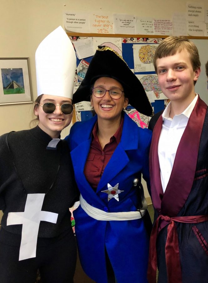 Seniors Sarah Faber, Gabriela (Gabi) Seguinot and Owen Peitsch dress as Bishop Bossuet, Fredrick the Great and John Locke (left to right). Each member of the AP European History class played the role of a prominent Enlightenment figure during a recent roundtable discussion.