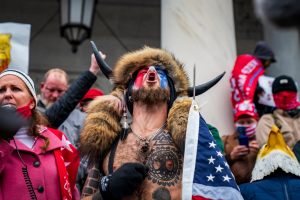 Jacob Chansley, also known as the Q Shaman, screams outside the U.S. Capitol. Chansley, a QAnon conspiracy theorist, was one of many recognizable figures who played a role in the deadly insurrection on Jan. 6. Chansley was later arrested and and brought up on U.S. federal charges of knowingly entering or remaining in any restricted building or grounds without lawful authority, and with violent entry and disorderly conduct on Capitol grounds.