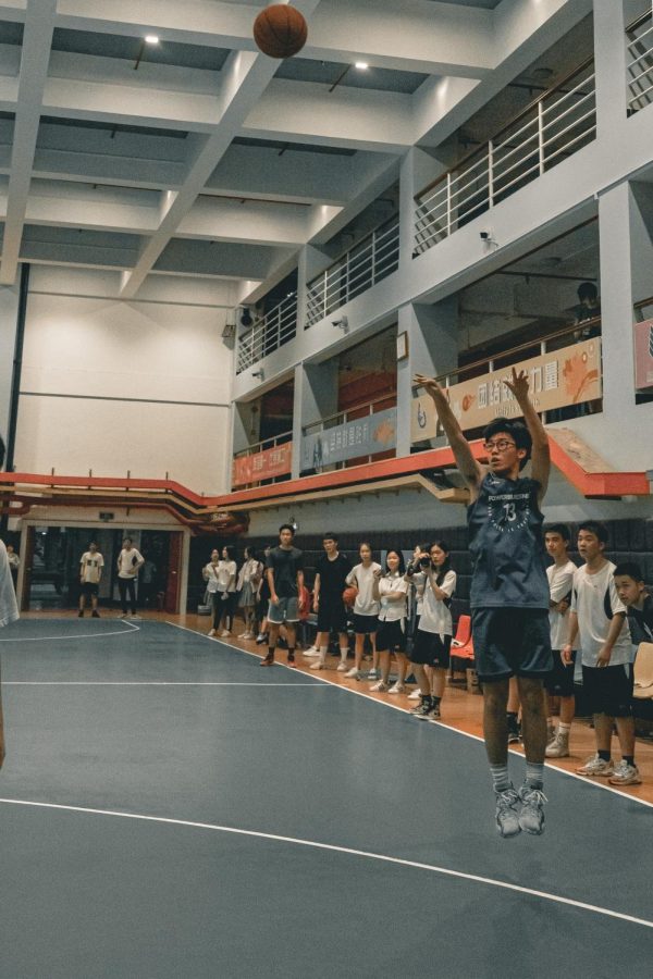Junior Allen Ning takes a three-point jump shot at a local school in Guangzhou, China. Ning
practiced with his local basketball team this past season, but he was unable to play in any games because he did not attend the school.