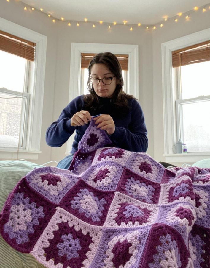 Emma Listokin 21 crochets a blanket, which will be donated to a child in a hospital or foster care.
