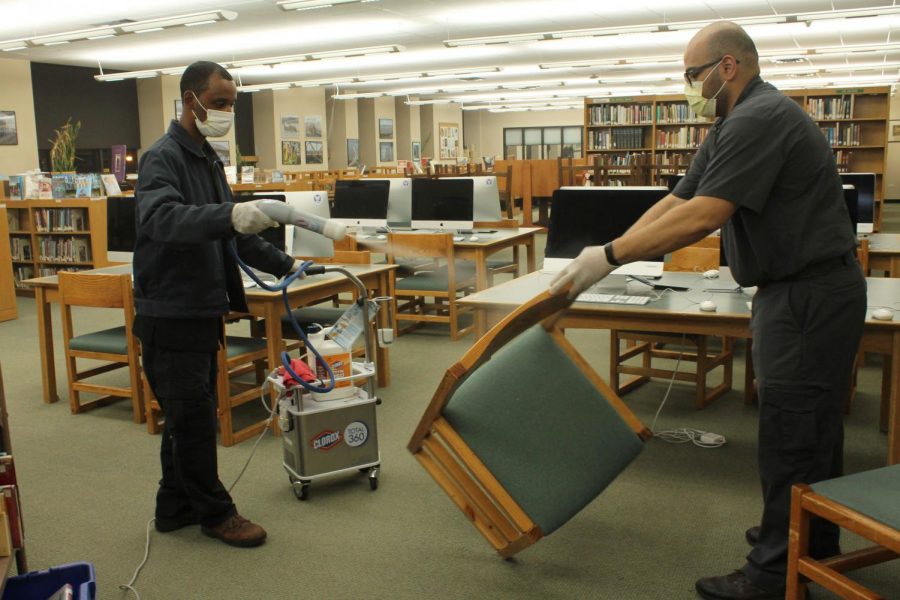 A cleaning crew sanitizes library furniture in March 2020. New cleaning equipment was one main area that Masters invested in during the early stages of the pandemic. 