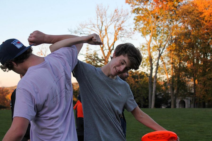 Juniors Baird Hruska and Ben New celebrate after their team scores a touchdown in Ultimate Frisbee practice.