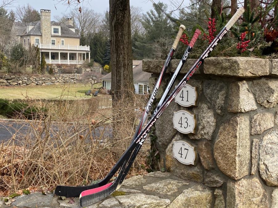 Hockey+sticks+sit+outside+of+a+Connecticut+residence+after+the+death+of+high+school+sophomore+Teddy+Balkind.+After+Balkinds+death%2C+many+people+put+hockey+sticks+outside+of+their+homes+as+a+tribute+to+his+life.+