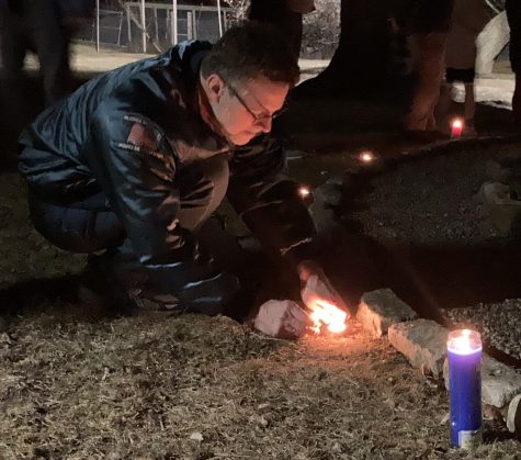 English teacher Paul West lights a candle around the labyrinth during the Candlelight Vigil for Peace in Ukraine on March 6. There were about 6 people in attendance.