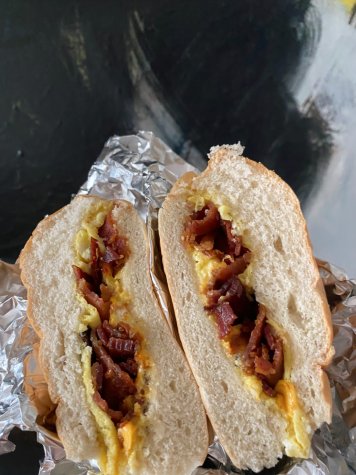 Sandwich split open with bacon, egg, and cheese