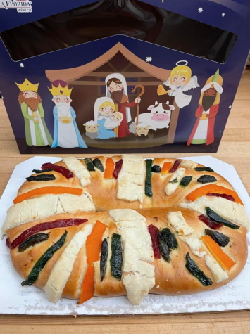 Three kings cake sat next to a nativity scene