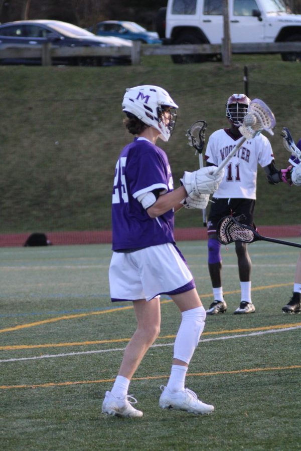 #25 Adrian Blanc ’23 controls the boys’ lacrosse offense from the wing in their home game against Wooster on April 8. Blanc is known for specializing in face-offs and uses his quick change of pace to get his team scoring opportunities.