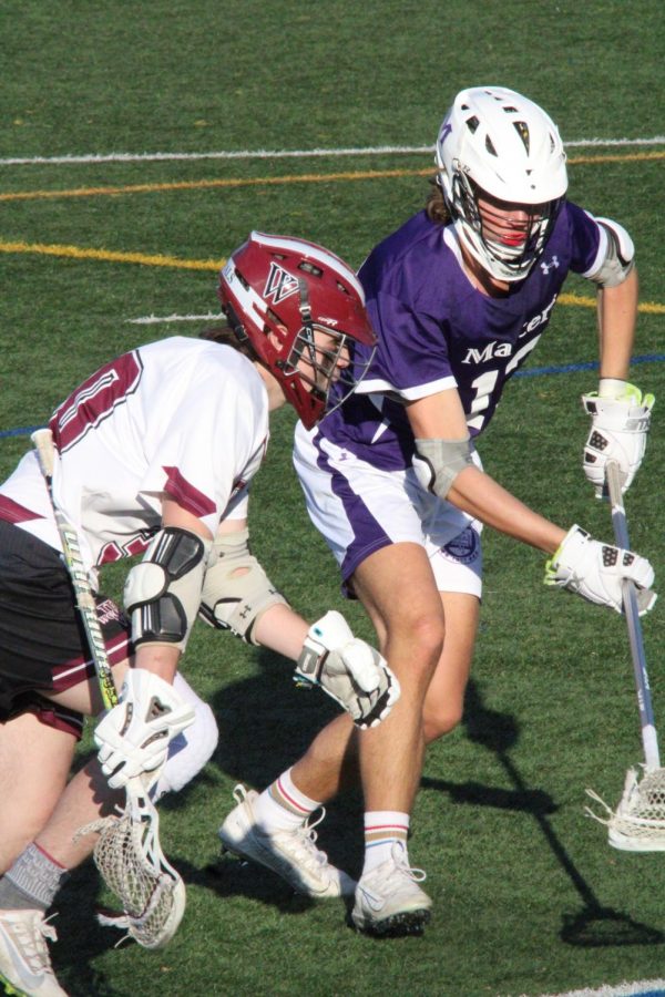 #13 Stephen Skrenta ’23 gets physical with a Wooster attacker during the varsity lacrosse home game on April 8. As an avid lacrosse player, Skrenta specializes in defending and uses the combination of his stocky build and the defensive long stick to keep opposing players in his reach.