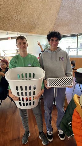 Freshmen Velizar Lazarov and Ernesto Bautista Luna carry their school supplies in containers on Anything But a Backpack Day.