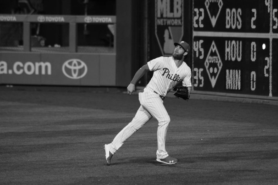 STAR OUTFIELDER BRYCE HARPER looks to catch a fly ball during a game in the regular season. Harper
has been a household name in baseball for years formerly playing with the Washington Nationals. The 30 year
old joined the Phillies in 2019 and has been playing with the team ever since. He is now a 7 time allstar and
has cemented himself as one of the sports greatest talents.