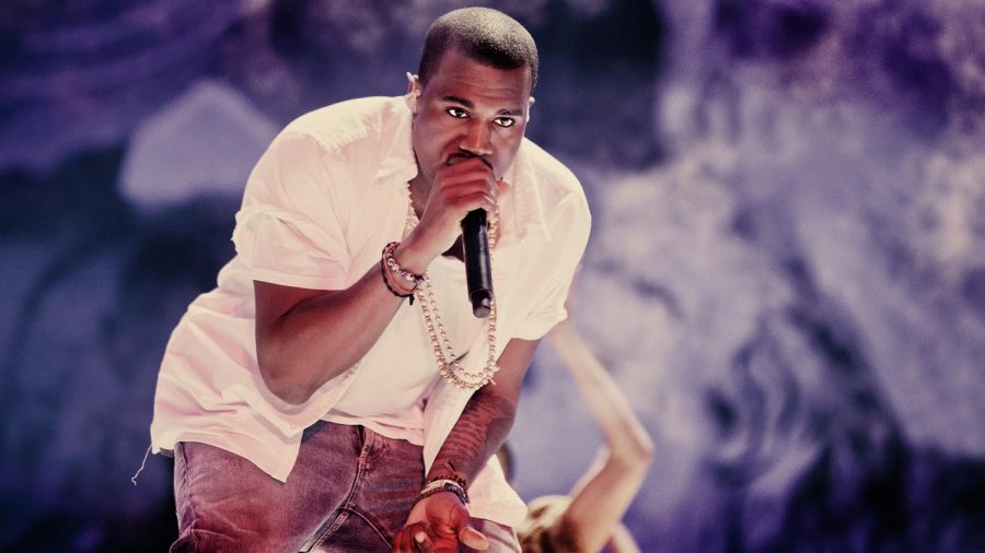 Rapper Kanye West (known as Ye) performing to a crowd.  