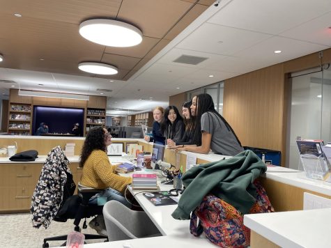 Valerie Blain, the new assistant librarian at The Masters School, converses with Masters students in the library. Blains focus this year has been on building community and relationships within the library.