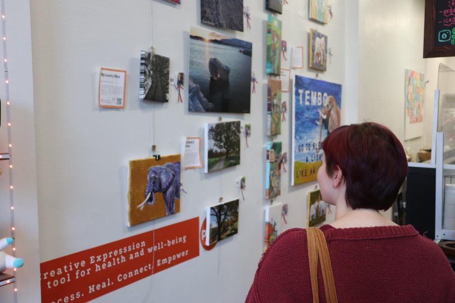 Senior Lorelei McCarthy  browsing through The Pods art gallery