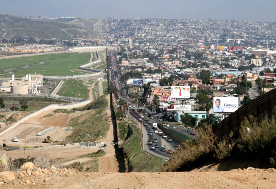 A small fence separates densely-populated Tijuana, Mexico, right, from the United States in the Border Patrols San Diego Sector. Construction is underway to extend a secondary fence over the top of this hill and eventually to the Pacific Ocean.