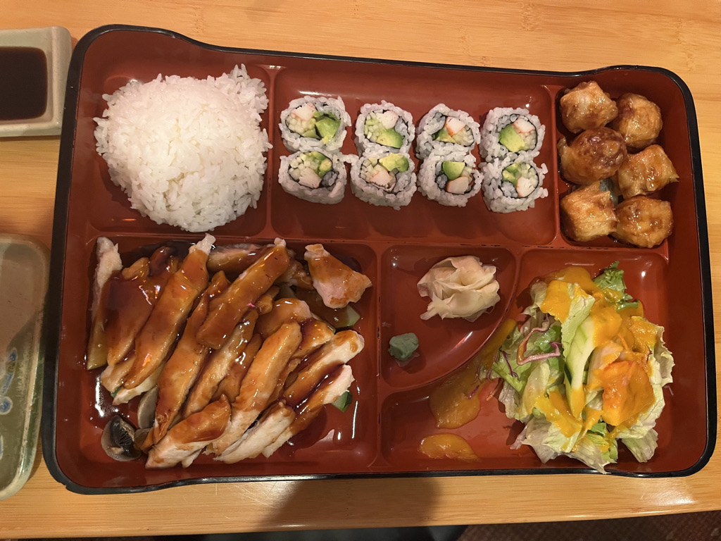 A Chicken Teriyaki bento box packed with California rolls, rice, shrimp shumai, seaweed salad and, of course, chicken teriyaki. 