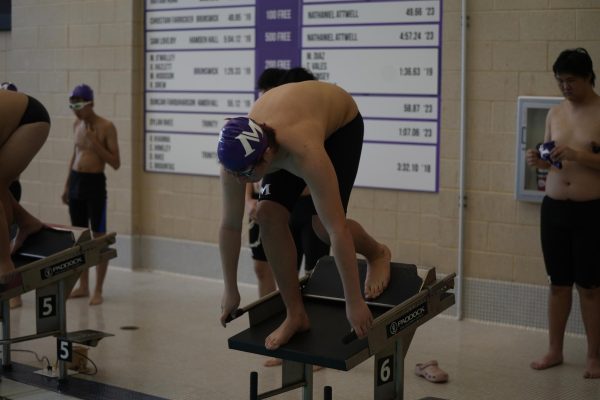 A student dives into Masters swimming pool in the teams first home meet of the winter season.
