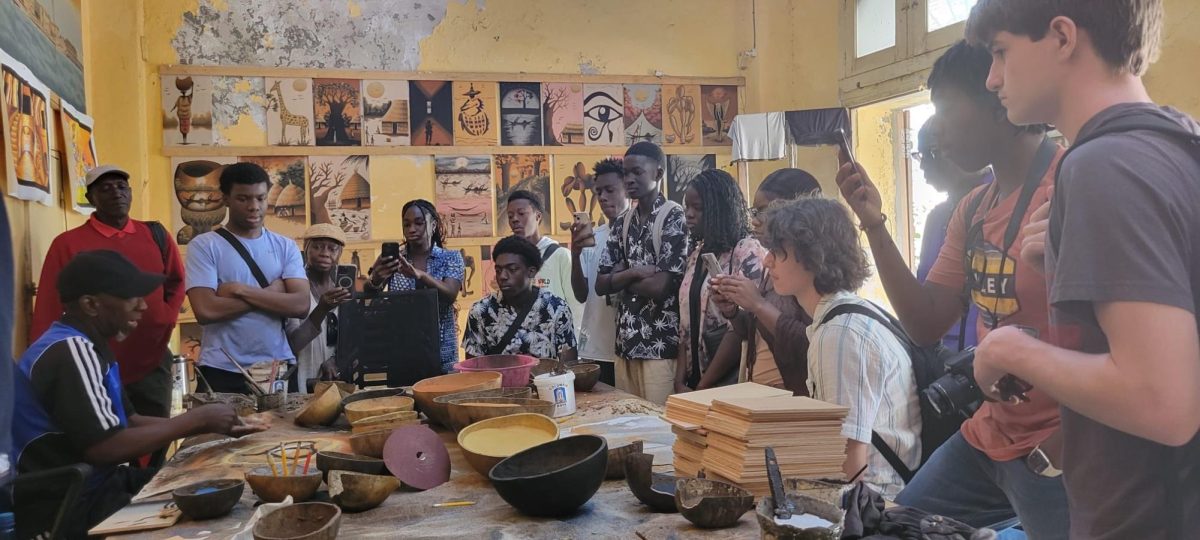 Students attentively listen as a local artisan in Senegal teaches them about traditional Senegalese craft-making techniques during a workshop.
Photo contributed by Abdoulaye Ngom.