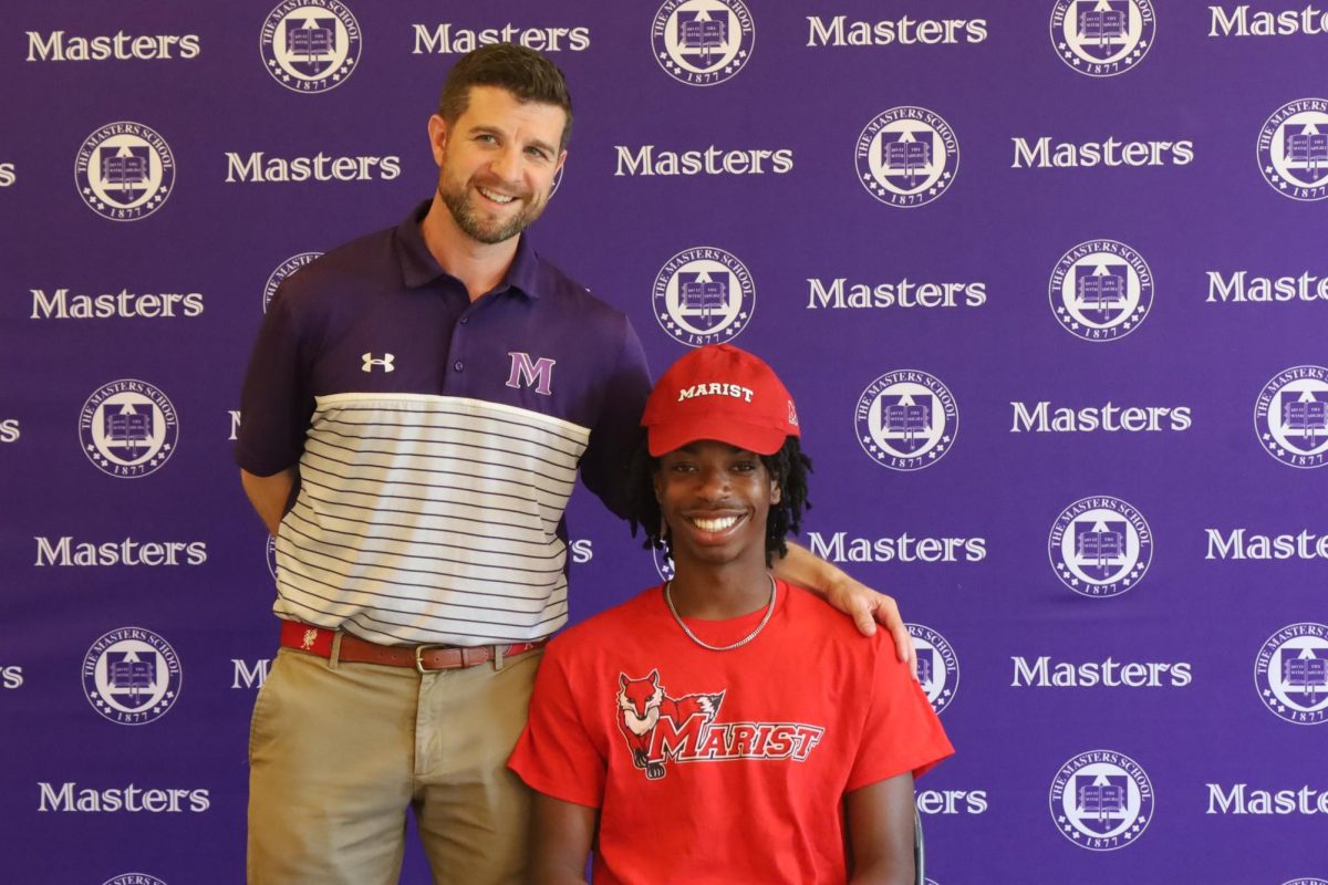 Emmanuel Harris with the athletic director, Logan Condon at the commitment signing ceremony. Harris will be running at Marist College, a division 1 program.