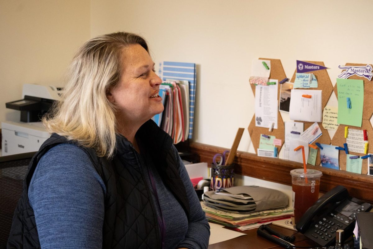 Karin O'Connor, chief of staff and executive assistant to the head of school, greets a guest to her office. She took a bit of time out of her busy day to share what it was like to come of age in the Bronx without a cell phone. 