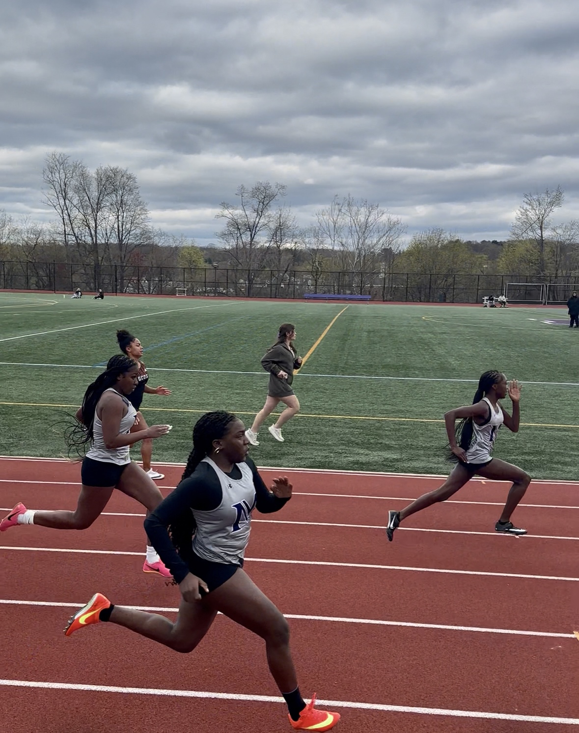 Masters students SeRy Jarrett '27, Dara Akinwande '27, and Jessica Grant '28, from left to right, ran the girls' 100m race. Grant earned third place in the race with a time of 13.71 seconds.
