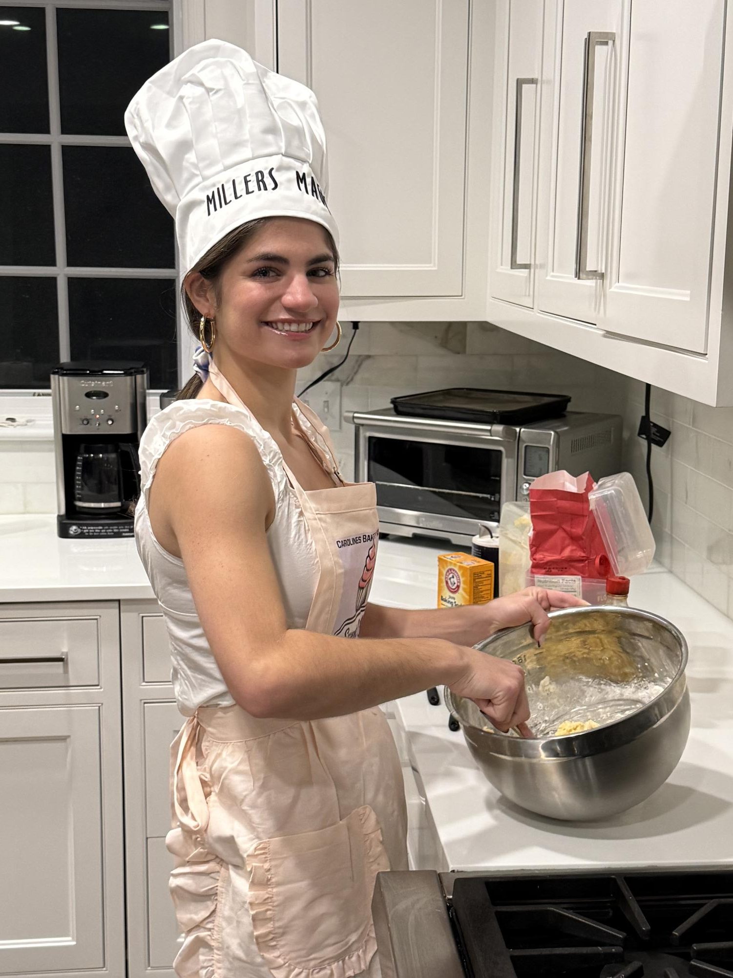 Caroline miller bakes pastries for upcoming orders.  Miller began baking at age ten, and has since turned her passion into both a successful business and a philanthropic endeavor.  