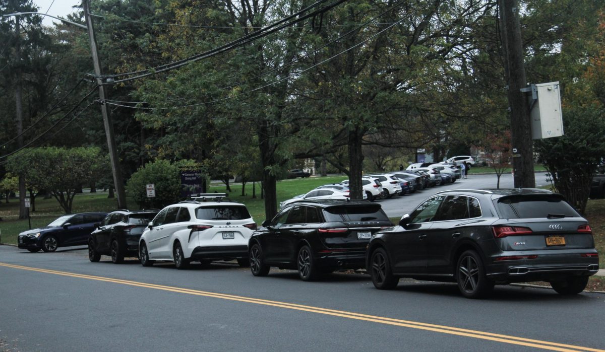 49 Clinton Avenue is lined with cars. This is where the junior drivers on campus park. 