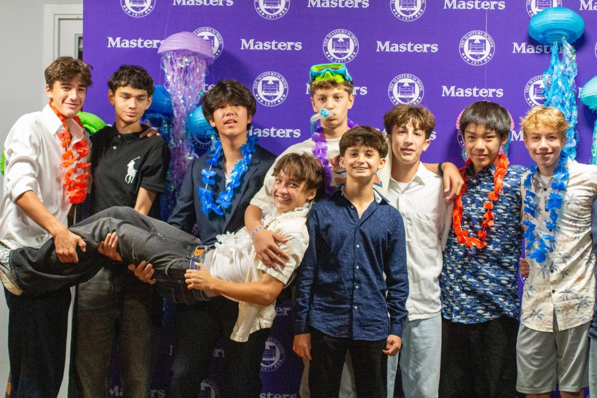  Ninth graders crowd together for a group photo at Homecoming. While the bright decorations added energy, many students felt the atmosphere and music didn’t fully match the excitement expected from the night.