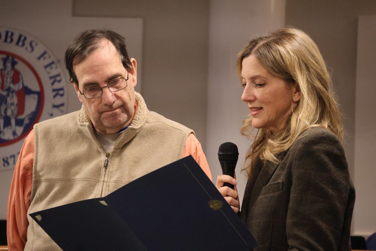 Mayor of Dobbs Ferry Christy Knell (right) reads a proclamation in honor of Ned Canora (left), celebrating 27 years of service to the Village through his work with the Dobbs Ferry Public Library. Knell, who was inaugurated earlier this year, replaced Vincent Rossillo, who served as mayor for six years. Knell will serve a two-year term, and will be eligible for re-election in 2027. 