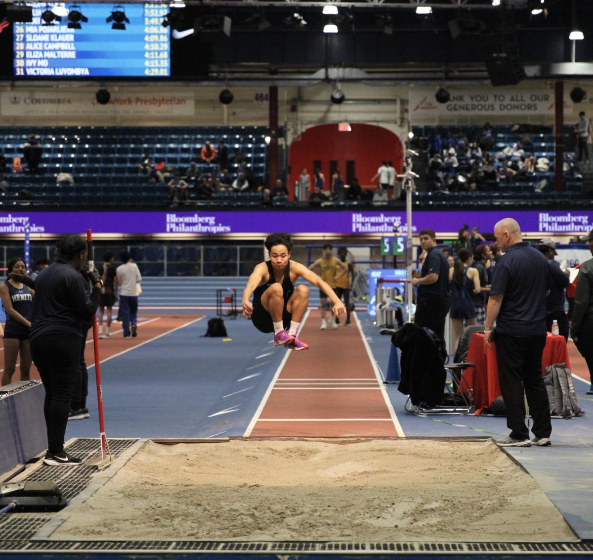 AJ NGUYEN GLIDES THROUGH the air at this year’s NYSAIS Championship. Though he initially joined the team to sharpen his basketball skills, Nguyen discovered his talent in the track and field.