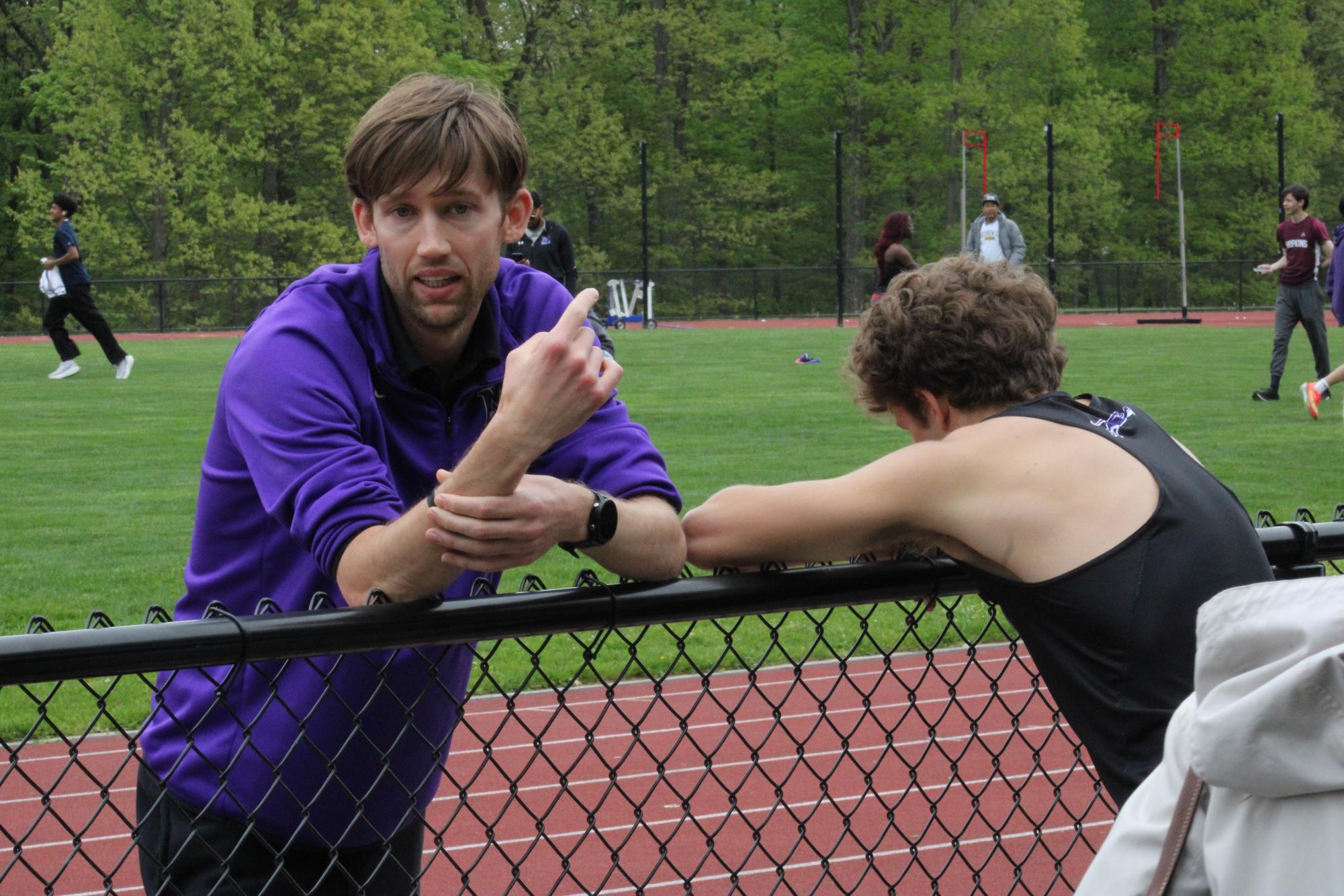 Track coach Ian Mook discusses strategy with runner Mason Rosenblatt at a track meet on May 9 at Hopkins. He has
helped to transform the track and field team into a very successful program, competing on a national level with significant suc-
cess. Mook’s contributions to the track team will be missed as he heads to his alma mater, Hackley, next year.