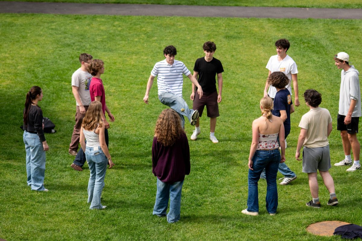 Maya Yoon '26 watches the ball as students gather in a hacky sack circle on the Quad. Over the past month, hacky sack has become one of the most visible trends on campus. The game brings students together through this relaxing outdoor activity.