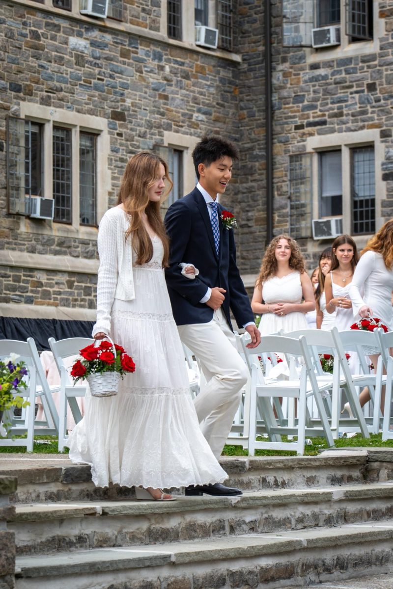 Mark He ‘26 and Ava Claire ‘26 join arms while preparing to join their classmates. Once at their seats, seniors listened to speeches from class president Jamie Milward ‘26, Head of Upper School Peter Newcomb, Class of 2026 Dean Darren Wood, guest speaker Cheryl Mills and more.