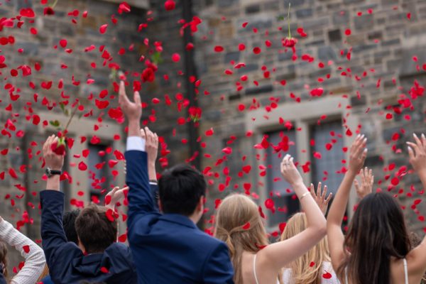 Students throw roses in the air as they officially transition from seniors to graduates. The students either wore a rose on their suit or carried a white basket of roses during the event. Many students also wore blue suits with a white and blue checkered tie or a white dress to match the white decorations. 