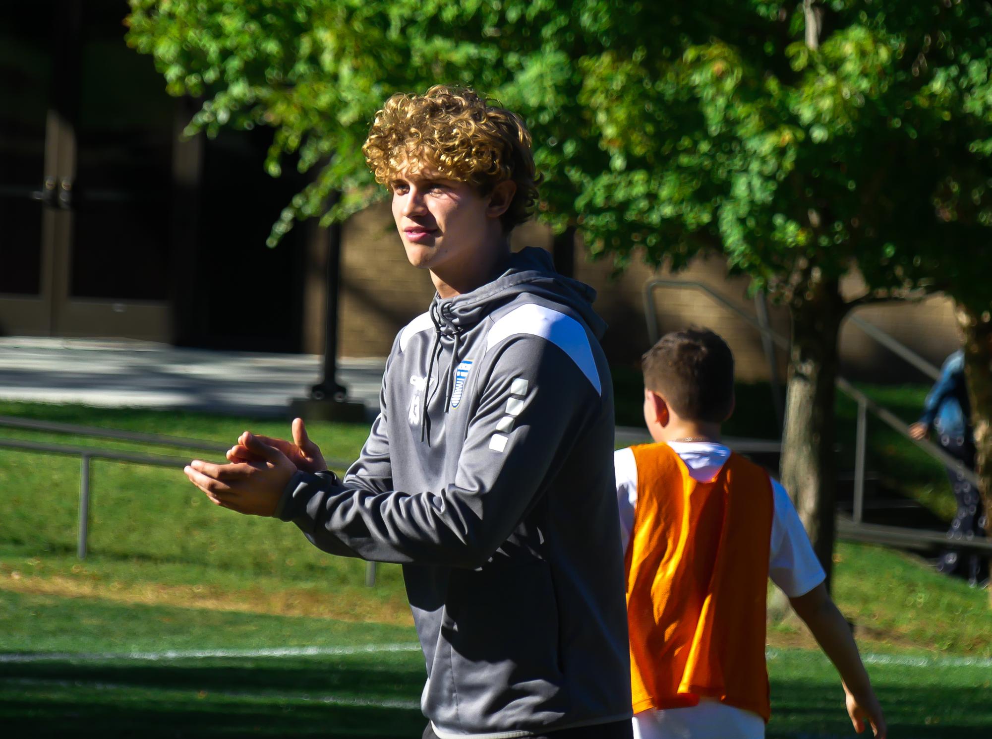 Former varsity captain Alan Eskenazi stands on the field as he transitions from teammate to assistant coach for the boys soccer program. Taking a gap year before playing collegiate soccer, Eskenazi leads drills for the Middle School and junior varsity team. His unique perspective brings an authentic and relatable energy
to the athletes.