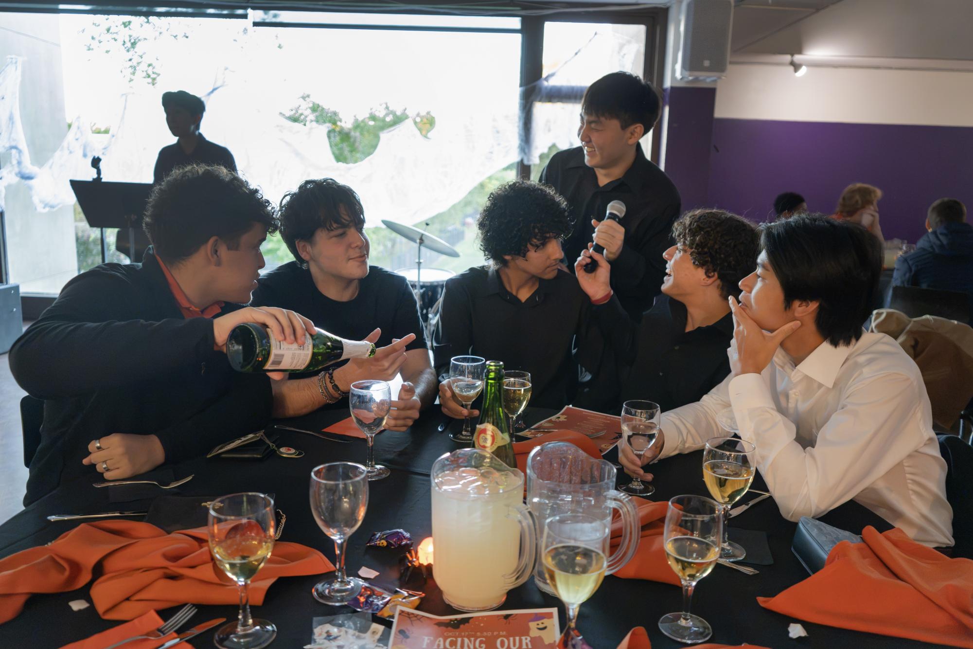 Thompson proctor Alex Cho '27 interacts with his friends before going on stage to be the emcee of Thompson dorm community dinner. This community dinner featured a band performance, reflections from student, and Halloween themed decorations. 